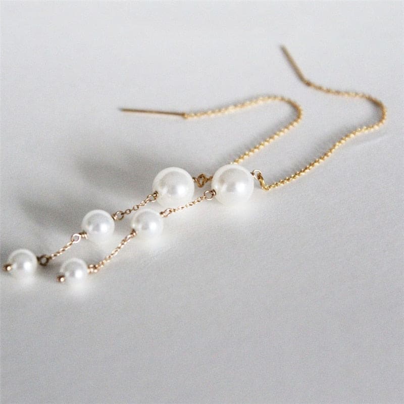 Boucle d’oreille chaine traversante en or avec perle
