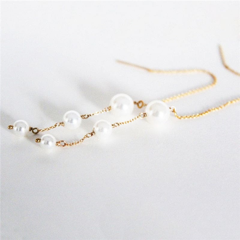 Boucle d’oreille chaine traversante en or avec perle